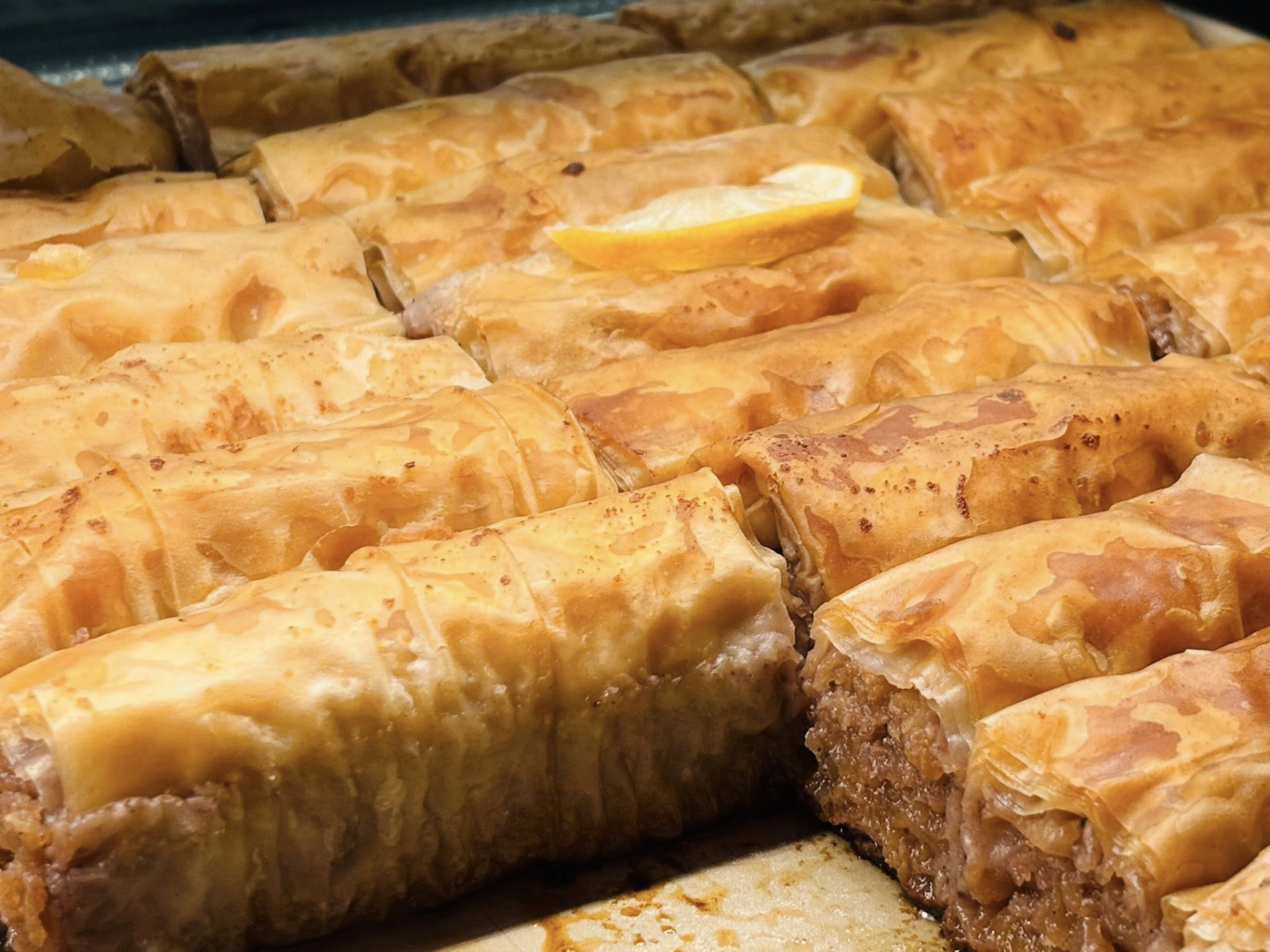 Golden rolled baklava cut into pieces and baked until crisp