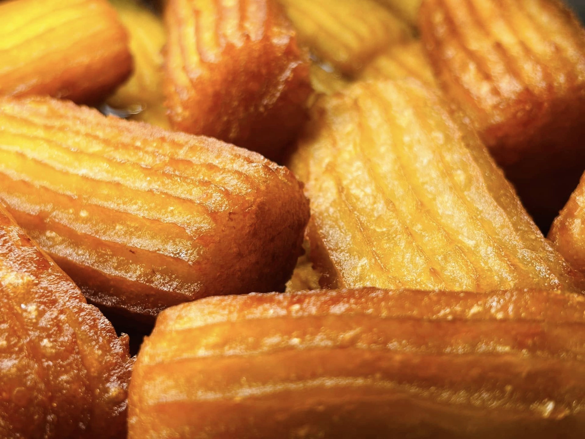 Close-up of tulumbe pastries glazed with syrup