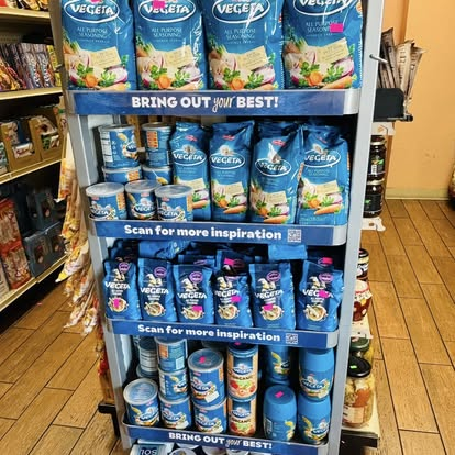 Vegeta seasoning display stand stocked with bags and shakers